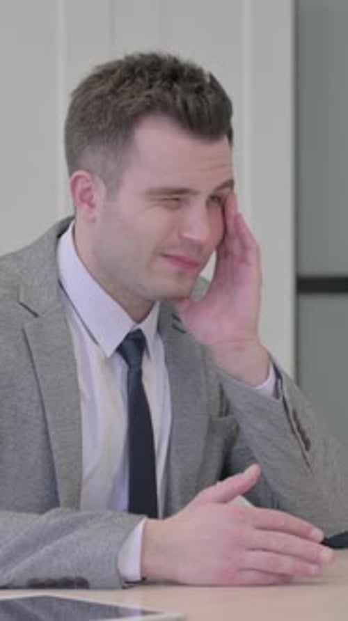 Stressed Man in Suit with Headache at Work