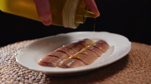 Herring with Oil on a White Plate