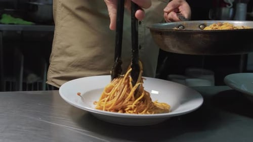 Chef Plates Spaghetti in Restaurant Kitchen