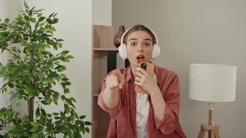 Enthusiastic Woman Dancing at Home with Headphones