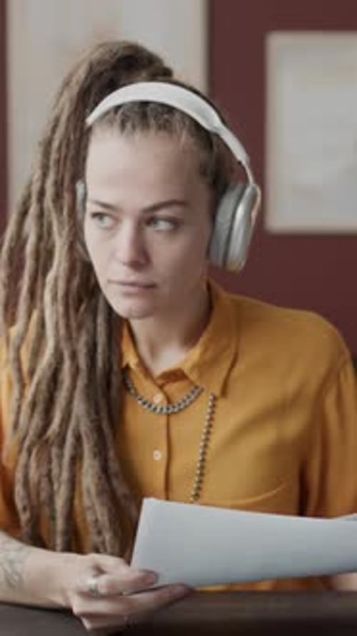 Vertical of Young Caucasian Female Interior Designer Working from Home