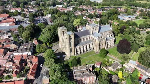 Aerial view of historic cathedral surrounded by trees and residential buildings