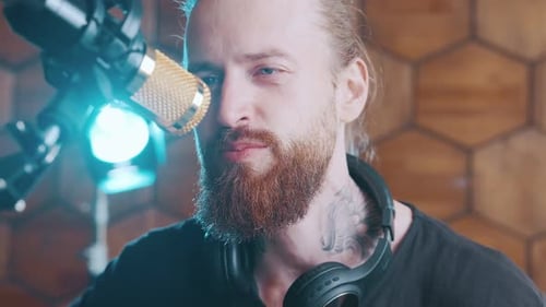 Young Bearded Caucasian Man Singer Performs Composition in Style of JazzRock