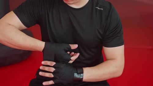 Man Wrapping Hands for Boxing in the Gym