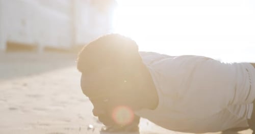 Beach, push ups or black man in training exercise or body workout for arms strength on sand