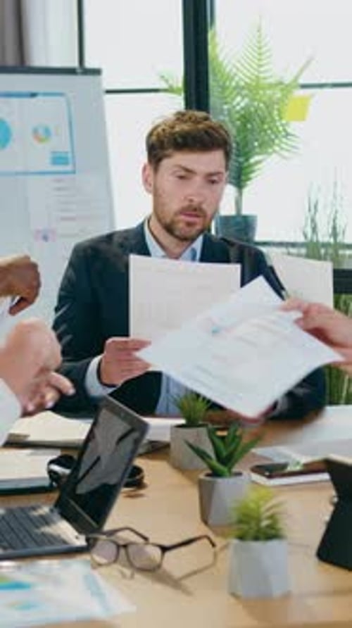 Businessman Receiving Documents at Office Meeting Indoors