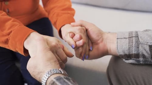 Married couple holding hands. Close-up hands.