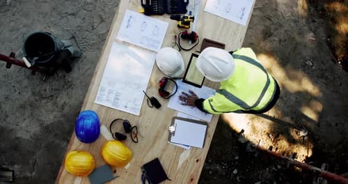 Top view, architect and planning on tablet with blueprint for construction project