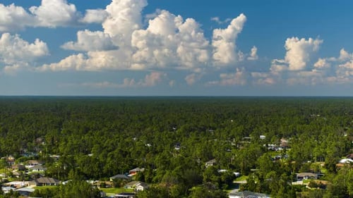 Florida Weather in Summer Rain Season Storm Clouds Forming on Blue Sky Over Rural Town Suburbs