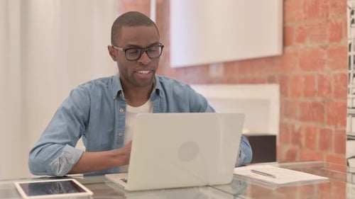 Man Works at Laptop in Modern Home