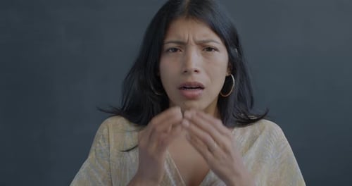 Woman Covering Mouth with Hands Looking Concerned