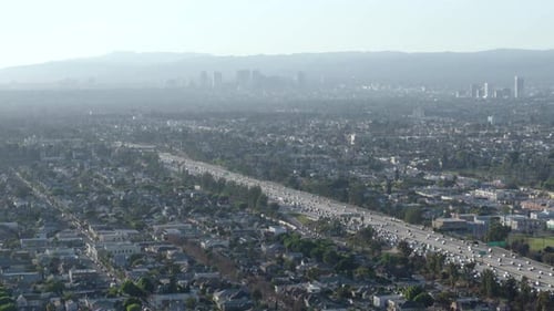Downtown Los Angeles skyline aerial drone flyover at sunset California USA