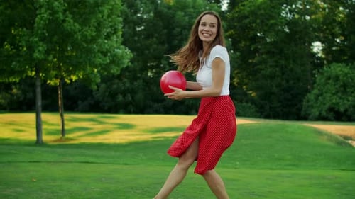 Smiling Woman And Boy Running In Green Meadow With Ball. Positive Mother And Son Playing With Bal...