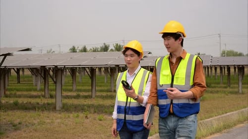 Maintenance Engineers Checking and Working at Ecological Solar Cell Farm