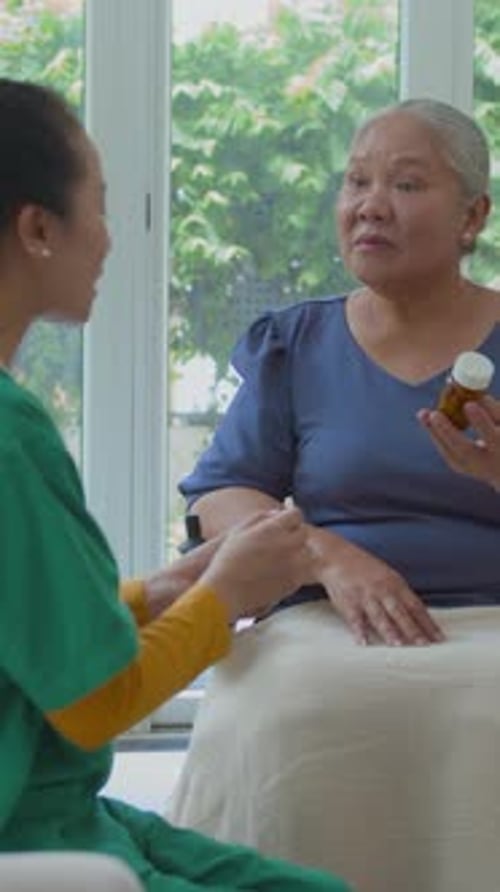 Senior Woman Receives Home Healthcare and Medicine