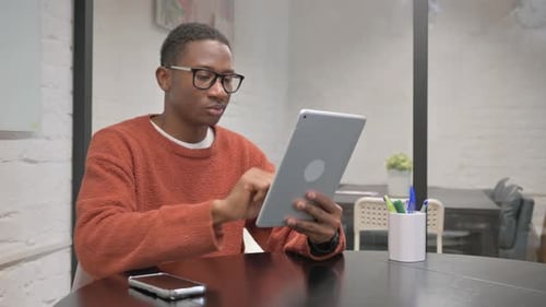 African American Man Working on Digital Tablet