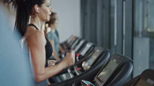 Beautiful Athletic Sports Woman Wearing Wireless Headphones, Listens to a Podcast or Sport Music Pl