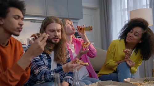 Four Multiethnic Friends Men Women Enjoying Home Party on Couch Eating Pizza Drinking Beer Together