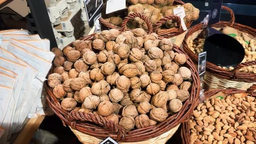 Fresh Walnuts and Almonds Displayed in Grocery Store Baskets
