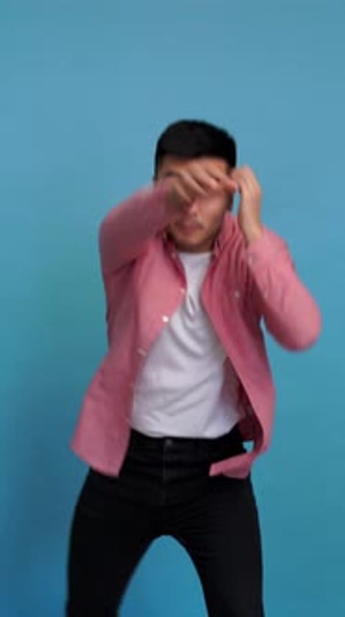 Strong Man Shows His Fists in Studio Vertical Video