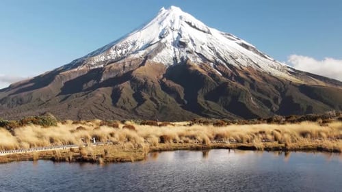 New Zealand famous Taranaki Volcano over tarn water, drone cinematic. Adventure New Zealand