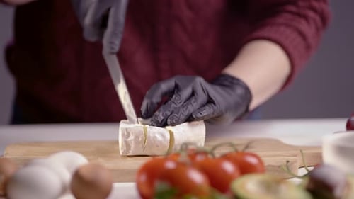 Chef Slicing Soft Brie Cheese with Precision on Wooden Board, Surrounded by Fresh Organic Ingredient