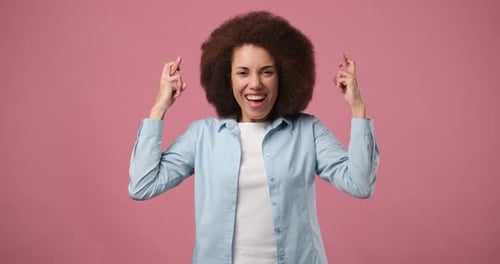 Woman Crossing Fingers Hoping for Good Luck