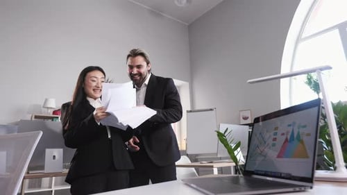 Multiracial Business Partners Throwing Papers in Office