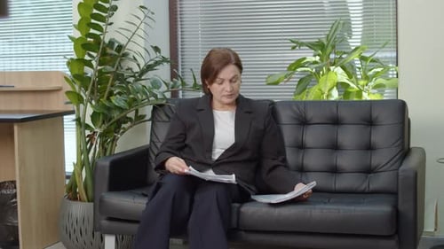 Female Executive Reviewing Financial Documents in Office