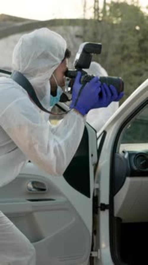 Investigators Photographing Car at Crime Scene