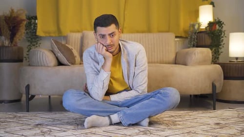 Depressed man alone at home.