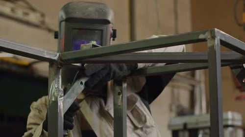 Welder Working with Metal and Sparks