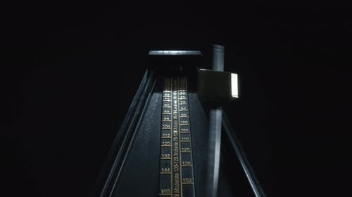 Vintage black metronome swinging back and forth