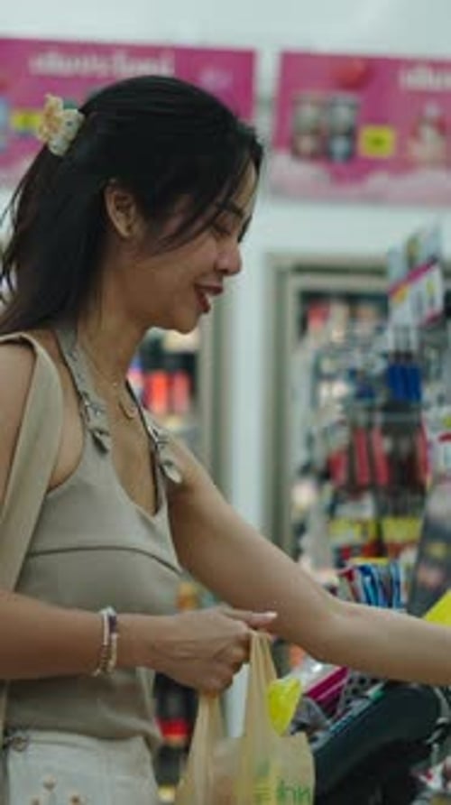 Customer Completing a Purchase at a Convenience Store Checkout