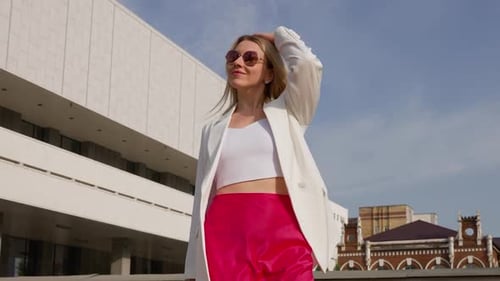 Happy Blond Woman Smiles and Walks in City Park on a Sunny Day Slow Motion