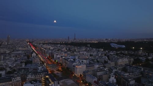 Cityscape of Metropolis Buildings Along Busy Wide Boulevard in Evening Eiffel Tower and Other Famous