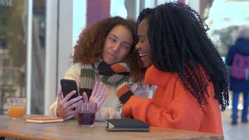 Friends Video Chatting at Urban Cafe