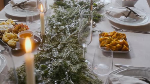Holiday Feast with Evergreen Garland and Candles