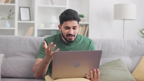 Man on Laptop Video Call at Home