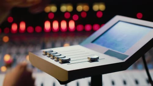 Man working a soundboard in audio studio