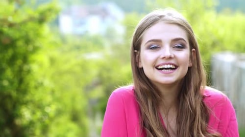 Smiling Young Woman Portrait in a Lush Setting