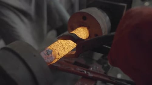 Removing Forged Steel From A Metal Lathe During Spinning Process