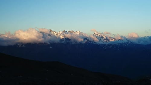 Timelapse of Caucasus Mountain Ridge with Clouds Moving Over Snowy Peaks Sunlight Changing Beautiful
