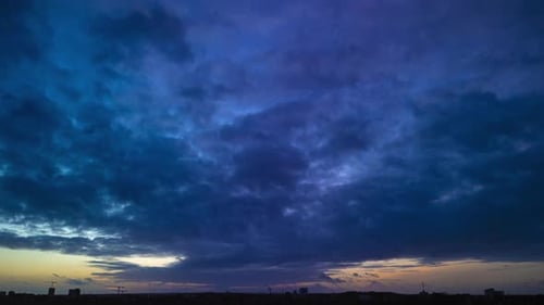 Aerial timelapse of dramatic cloudscape over urban area