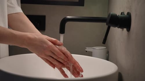 Closeup Side View of Unrecognizable Female Hands Have Finished Washing and Closing Tap Water Stops