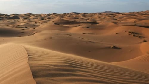 Sand blowing away in the Sahara desert near Merzouga, Morocco. Static handheld shot, low perspective