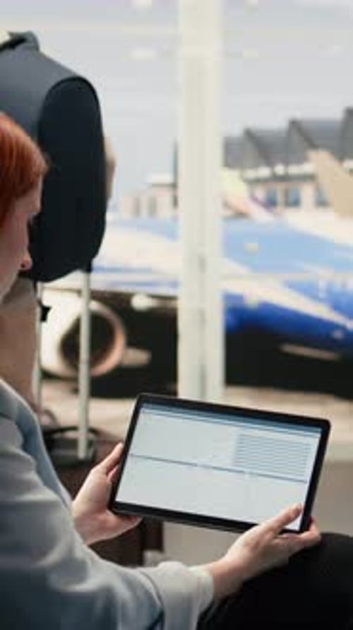 Vertical Video Remote Accountant Reviewing Reports and Data Charts on Laptop in Airport