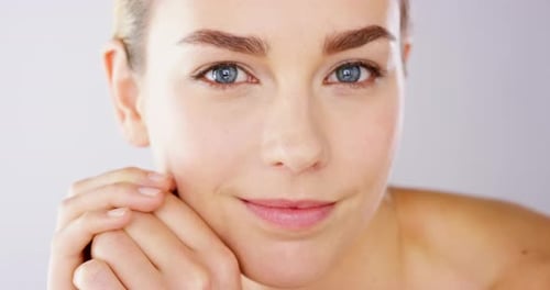 4k video footage of an alluring beautiful woman posing against a studio background