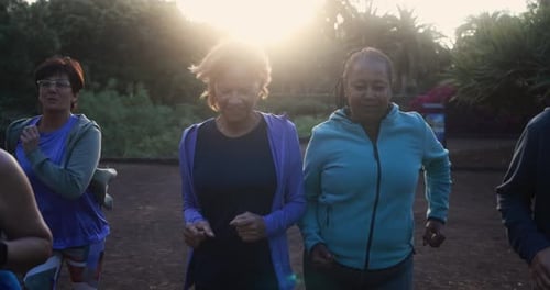 Fit senior people running at city park - Group of elderly friends doing sport workout together