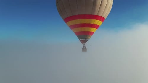 Hot Air Balloon Drifting Through a Misty Sky